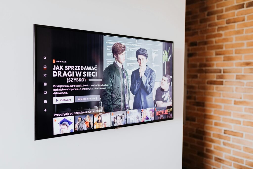 Smart TV displaying streaming content in modern living room setting with exposed brick wall.